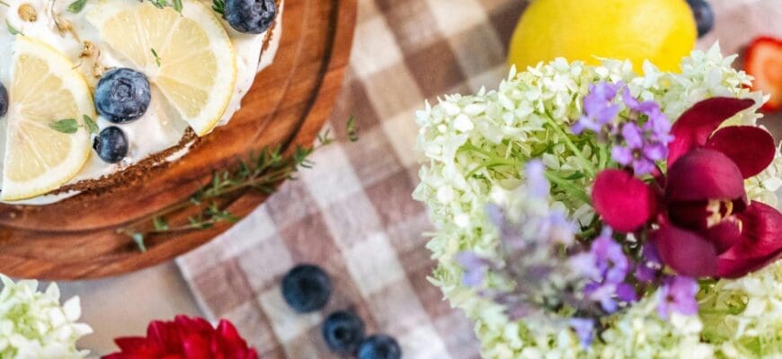 A Table Setting with a Lemon Blueberry Tart and Flower Arrangements